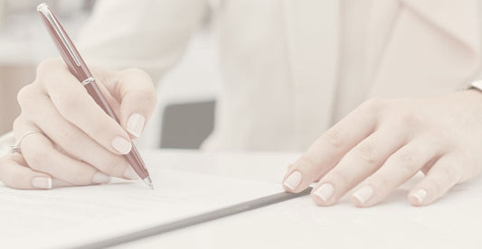 Woman signing documents as an executor of her parents estate